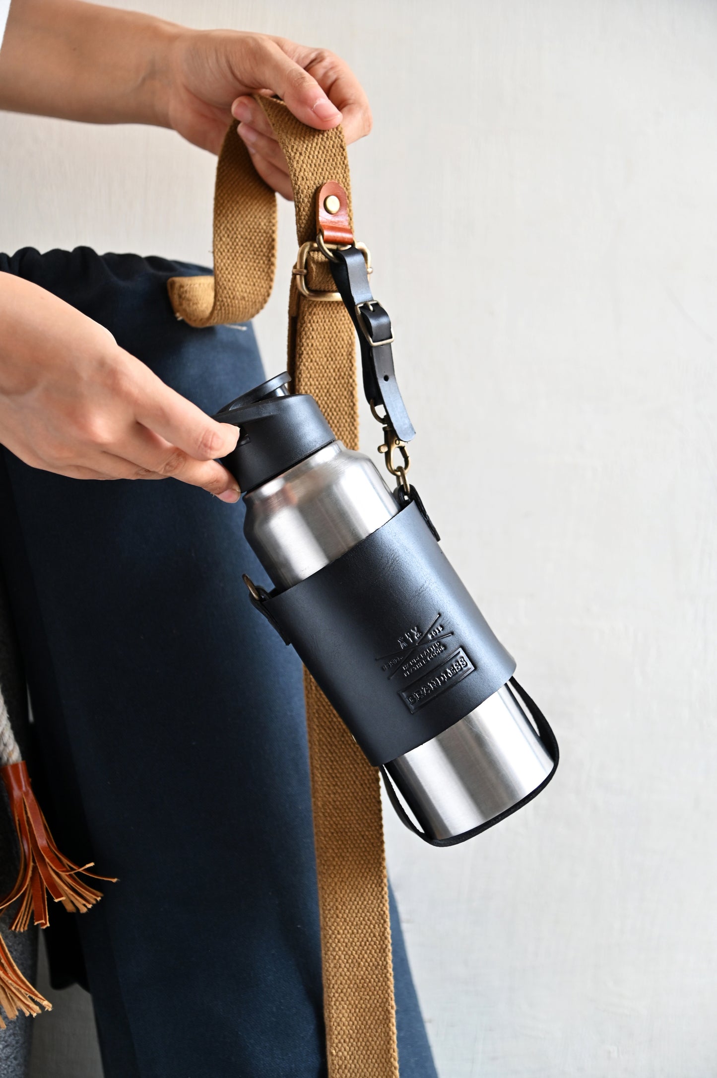 Handcrafted leather bottle carrier with crossbody & hand strap