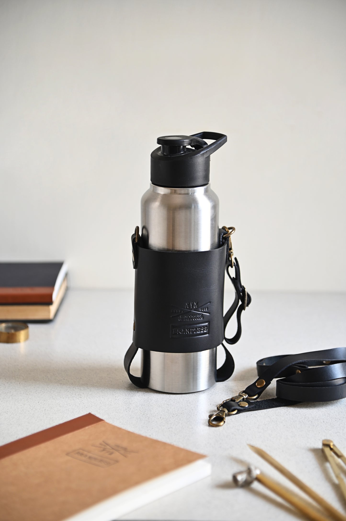 Handcrafted leather bottle carrier with crossbody & hand strap