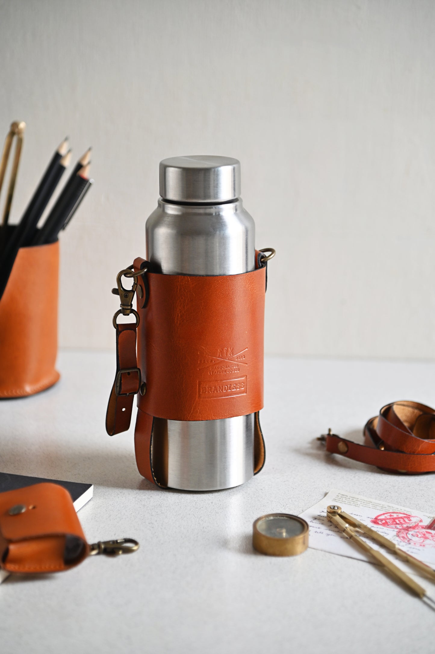 Handcrafted leather bottle carrier with crossbody & hand strap
