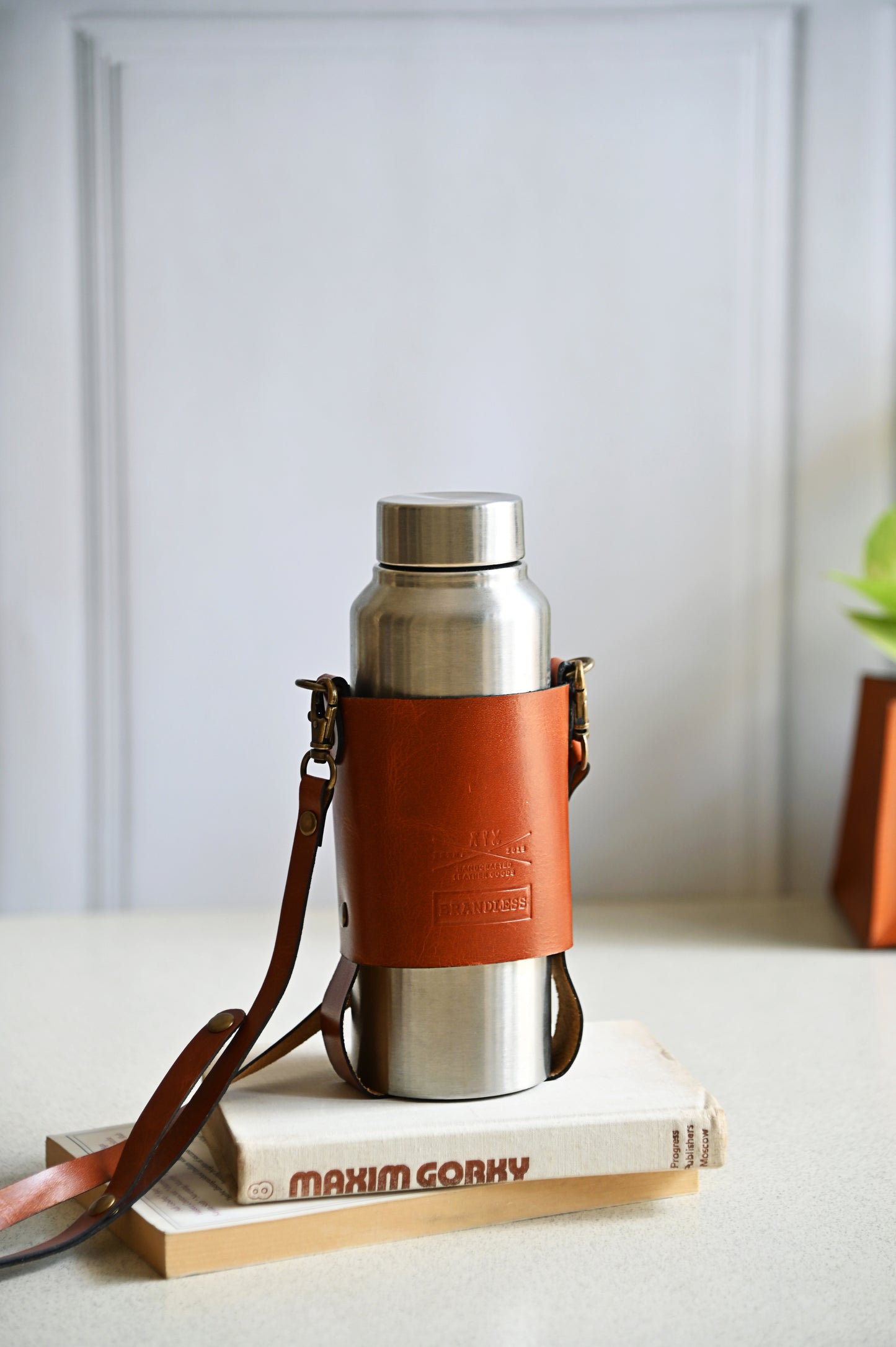 Handcrafted leather bottle carrier with crossbody & hand strap