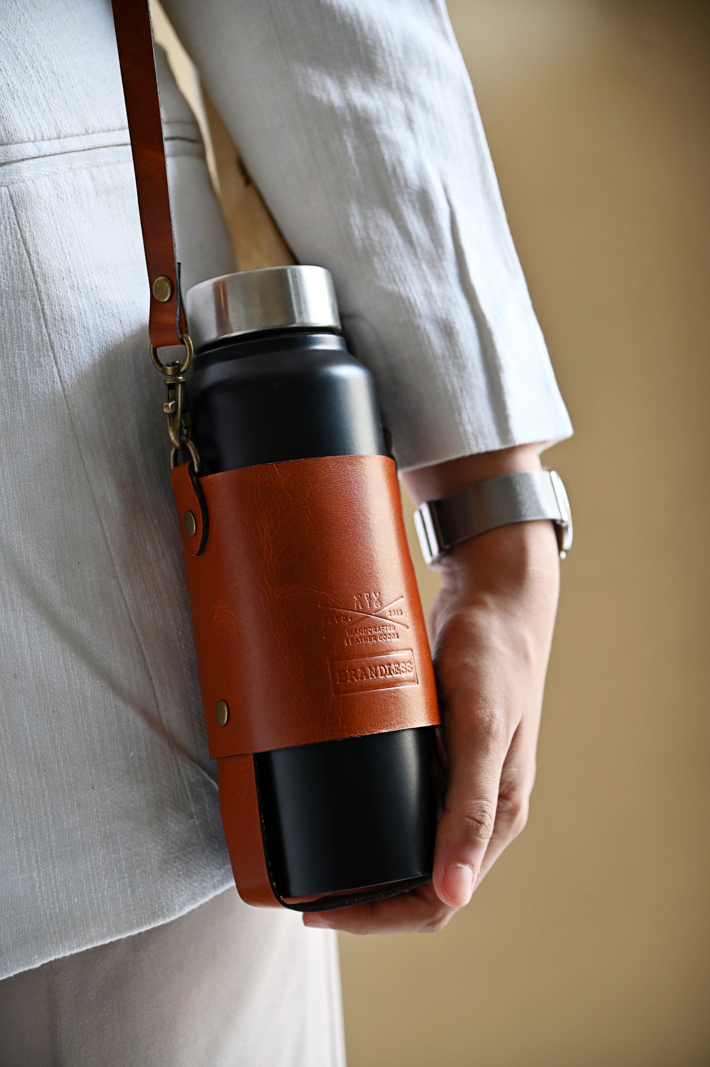 Handcrafted leather bottle carrier with crossbody & hand strap