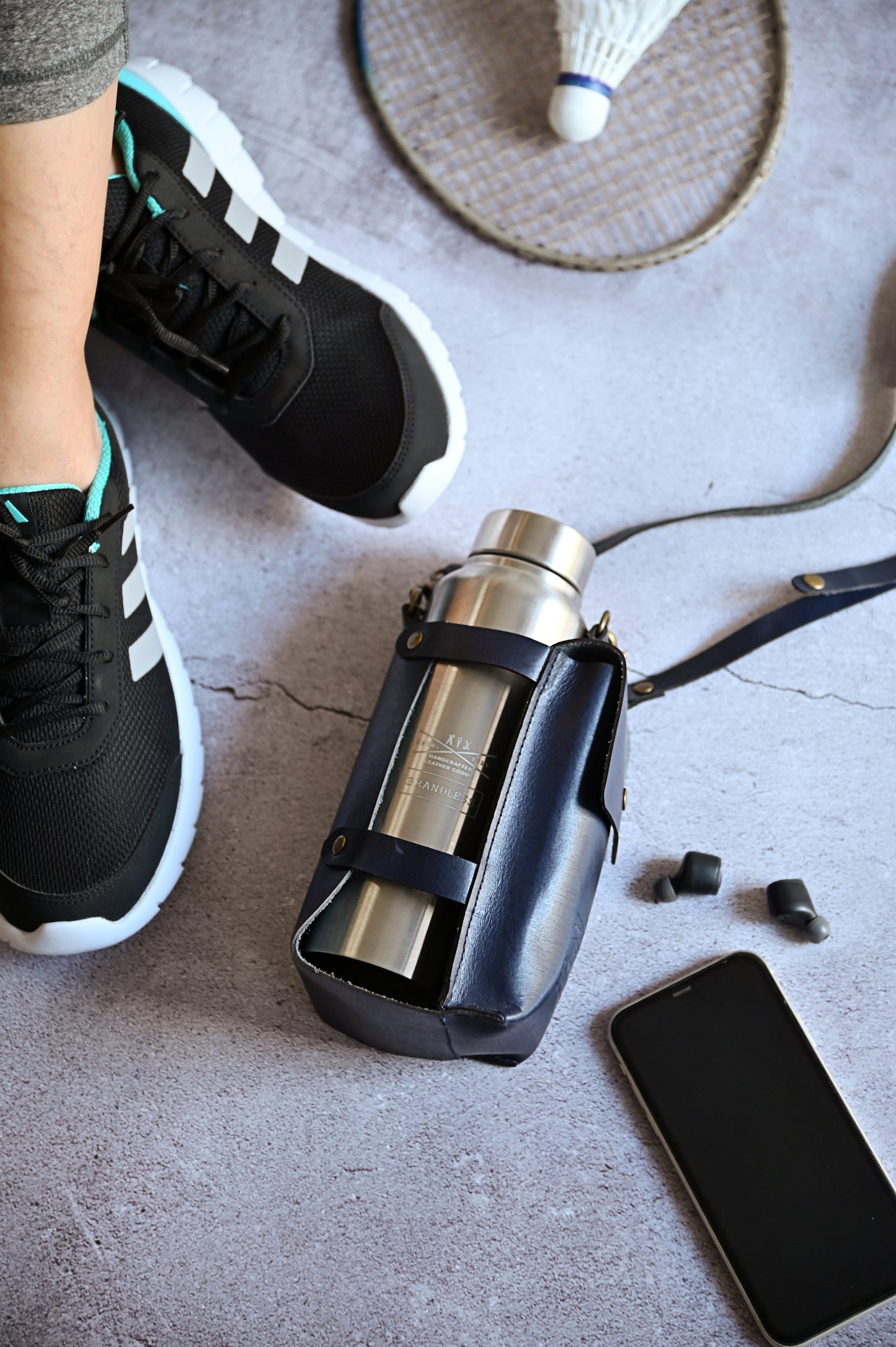 Midnight Blue handcrafted leather bottle case with utility pocket and steel flask, worn crossbody