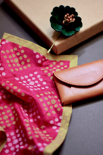 Gift hamper for men with a hand block printed silk pocket square, leather lapel pin, and leather card case.