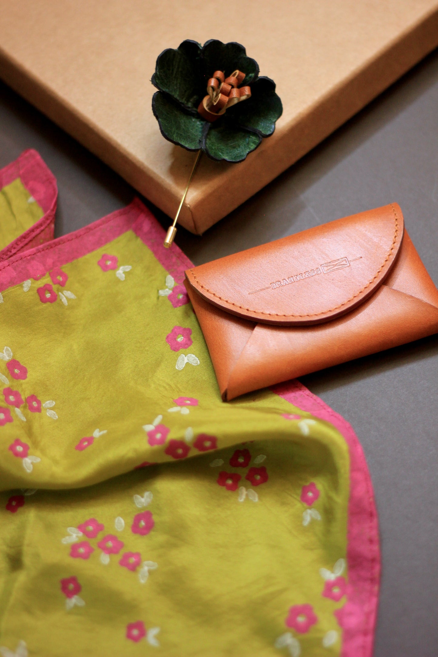 Gift hamper for men with a hand block printed silk pocket square, leather lapel pin, and leather card case.