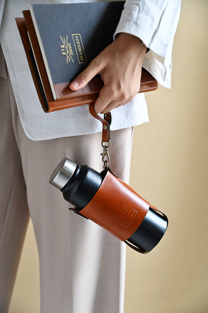 Handcrafted leather bottle carrier with crossbody & hand strap